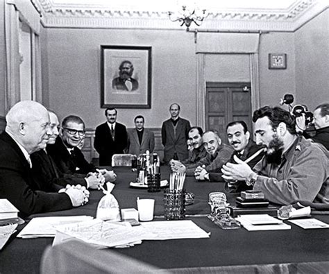 Fidel Castro smoking a cigar and wearing two Rolex .